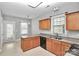 Functional kitchen with wood cabinets, laminate counters, and access to the backyard at 6705 E Douglas Park Dr, Huntersville, NC 28078