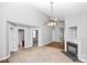 Open living room featuring a fireplace, ceiling fan, and access to the bathroom and other rooms at 6705 E Douglas Park Dr, Huntersville, NC 28078