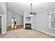 Spacious living room with fireplace, ceiling fan, neutral walls and plenty of natural light at 6705 E Douglas Park Dr, Huntersville, NC 28078