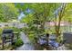 Landscaped backyard featuring patio furniture, grill, white fencing, and mature trees at 6827 Dunton St, Huntersville, NC 28078