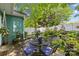 Landscaped backyard featuring patio furniture, grill, white fencing, and mature trees at 6827 Dunton St, Huntersville, NC 28078