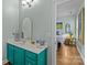 Bathroom with brightly painted vanity, mirror, and connection to bedroom at 6827 Dunton St, Huntersville, NC 28078