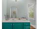 Well-lit bathroom with turquoise vanity, countertop space, and decor at 6827 Dunton St, Huntersville, NC 28078
