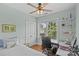 Bedroom with natural light, open shelving, hardwood floors, ceiling fan, and view of backyard at 6827 Dunton St, Huntersville, NC 28078