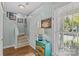Bright foyer with hardwood floors and a staircase, complemented by a colorful accent cabinet at 6827 Dunton St, Huntersville, NC 28078