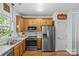Updated eat-in kitchen with wood cabinets, stainless steel appliances, and hardwood flooring at 6827 Dunton St, Huntersville, NC 28078