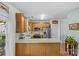 Updated eat-in kitchen featuring stainless appliances, wooden cabinets and a window at 6827 Dunton St, Huntersville, NC 28078