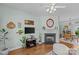 Cozy living room with a fireplace, hardwood floors, and bright natural light at 6827 Dunton St, Huntersville, NC 28078