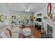 Cozy living room featuring hardwood floors, a fireplace, and a large window with natural light at 6827 Dunton St, Huntersville, NC 28078