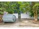 Exterior view of home with a parking area behind a privacy fence. Car is covered with gray car cover at 6827 Dunton St, Huntersville, NC 28078