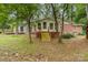 View of the home's backyard with mature trees, patio, and steps to the home at 6934 Lockhart Rd, Sharon, SC 29742