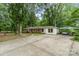 View of a brick home with a covered parking area, spacious driveway and ample space for parking at 6934 Lockhart Rd, Sharon, SC 29742