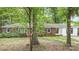 Charming single-story home with a brick facade, bright windows, and a lush, shaded front yard at 6934 Lockhart Rd, Sharon, SC 29742