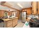 View of the kitchen with stainless steel refrigerator and an island overlooking the adjacent living room at 6934 Lockhart Rd, Sharon, SC 29742