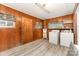 Functional laundry room featuring modern appliances, wood-paneled walls, and ample space at 6934 Lockhart Rd, Sharon, SC 29742