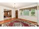 Cozy living room with hardwood floors, classic wood door, and large window offering plenty of natural light at 6934 Lockhart Rd, Sharon, SC 29742