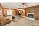 Open-concept living area featuring a brick fireplace, kitchen bar, and access to an adjacent room at 6934 Lockhart Rd, Sharon, SC 29742