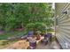 Cozy back patio with outdoor seating and a fire pit, perfect for enjoying the surrounding lush greenery at 705 Moss Creek Dr, Matthews, NC 28105