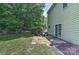 Peaceful patio area with outdoor seating, adjacent to a well-maintained yard and lush greenery at 705 Moss Creek Dr, Matthews, NC 28105