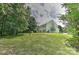 Expansive backyard featuring a well-maintained lawn and mature trees, providing ample space for outdoor activities at 705 Moss Creek Dr, Matthews, NC 28105
