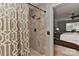 Bathroom with tiled walk-in shower and doorway view of the bedroom at 705 Moss Creek Dr, Matthews, NC 28105