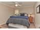 Neutral bedroom with a queen-sized bed, side tables with lamps, and large window at 705 Moss Creek Dr, Matthews, NC 28105