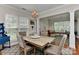Open concept dining room with wood floors, a decorative chandelier, and a view into the living room at 705 Moss Creek Dr, Matthews, NC 28105