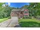 Charming two-story brick home with a well-manicured lawn and a two-car attached garage at 705 Moss Creek Dr, Matthews, NC 28105
