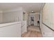 Upstairs hallway features neutral paint and trim, with an open doorway to a bathroom at 705 Moss Creek Dr, Matthews, NC 28105