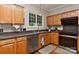 Functional kitchen with stainless steel appliances, wood cabinets, and a view of the backyard at 705 Moss Creek Dr, Matthews, NC 28105