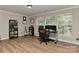 Well-lit office space featuring large windows, built-in bookshelves, and a comfortable gaming chair at 705 Moss Creek Dr, Matthews, NC 28105