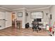 Inviting office with hardwood floors, a modern desk setup, and ample bookshelf space at 705 Moss Creek Dr, Matthews, NC 28105