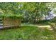 Back yard featuring healthy green grass and mature shade trees at 7226 Reedy Creek Rd, Charlotte, NC 28215