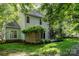 A charming backyard showcasing the home's light blue siding and providing an inviting outdoor space for relaxation and entertainment at 7226 Reedy Creek Rd, Charlotte, NC 28215