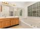 Bright bathroom with a large soaking tub, double vanity, and natural light at 7226 Reedy Creek Rd, Charlotte, NC 28215