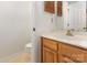 Bathroom with wood vanity, marble countertop and tiled floors at 7226 Reedy Creek Rd, Charlotte, NC 28215