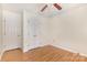 Bedroom with vinyl floors featuring double door closet and a window providing natural light at 7226 Reedy Creek Rd, Charlotte, NC 28215