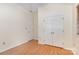 Bedroom with vinyl floors featuring double door closet and a window providing natural light at 7226 Reedy Creek Rd, Charlotte, NC 28215