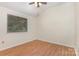 Bright bedroom featuring neutral walls, modern ceiling fan and hardwood flooring with natural light at 7226 Reedy Creek Rd, Charlotte, NC 28215