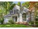 Charming two-story home featuring a well-manicured lawn, two car garage, and mature shade trees at 7226 Reedy Creek Rd, Charlotte, NC 28215
