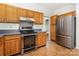 Well-lit kitchen featuring stainless steel appliances and wooden cabinetry at 7226 Reedy Creek Rd, Charlotte, NC 28215