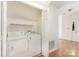 Convenient laundry room with washer, dryer, and storage shelving at 7226 Reedy Creek Rd, Charlotte, NC 28215