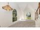 Bright living room featuring neutral carpet, vaulted ceilings and multiple large windows at 7226 Reedy Creek Rd, Charlotte, NC 28215