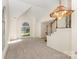 Bright living room featuring neutral carpet, vaulted ceilings and multiple large windows at 7226 Reedy Creek Rd, Charlotte, NC 28215
