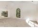 Bright living room featuring neutral carpet, vaulted ceilings and multiple large windows at 7226 Reedy Creek Rd, Charlotte, NC 28215