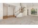Open-concept living area with staircase, hardwood accents, and neutral carpet at 7226 Reedy Creek Rd, Charlotte, NC 28215