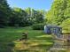 Spacious backyard with shed, green grass, and mature trees at 850 Meadowbend Dr, York, SC 29745