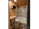 Modern bathroom with wood paneling, tiled shower, and natural wood vanity at 850 Meadowbend Dr, York, SC 29745
