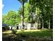 Single story home with wooded lot; covered parking visible in the background, small storage shed at 850 Meadowbend Dr, York, SC 29745