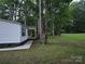 Charming home exterior with covered porch and lush, mature landscaping at 850 Meadowbend Dr, York, SC 29745